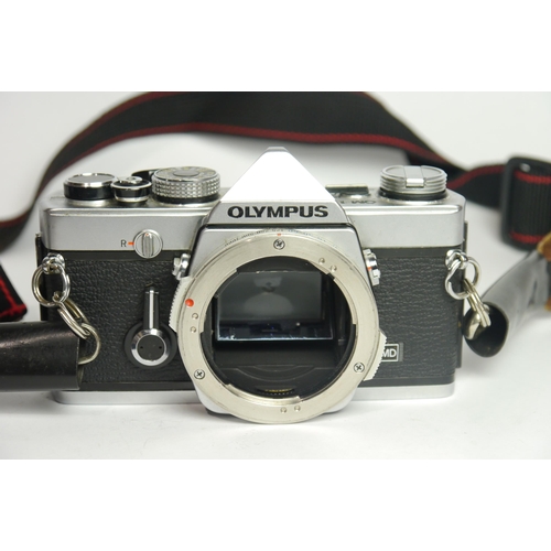 6041 - A Cased Olympus OM-1 & OM40 w/ Two Olympus Om-System Zuiko Auto-S 50mm F1.8 lenses & A Olympus OM-Sy... 