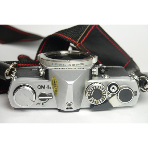 6041 - A Cased Olympus OM-1 & OM40 w/ Two Olympus Om-System Zuiko Auto-S 50mm F1.8 lenses & A Olympus OM-Sy... 