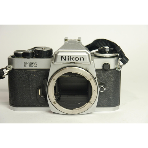 6009 - A Nikon FE2 SLR 35mm Film camera w/ Nikon MD-12 Motor Drive
Both Camera & Motor Drive come with Inst... 