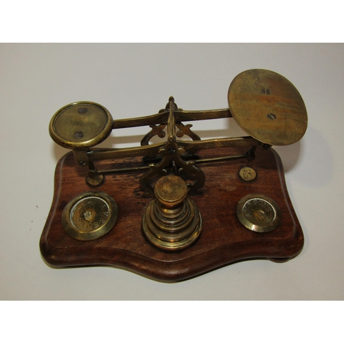 4262 - A set of A.K & Sons brass weights with a set of mahogany postal scales