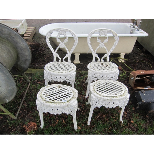 7033 - A pair of decorative cast alloy garden chairs and matching low tables