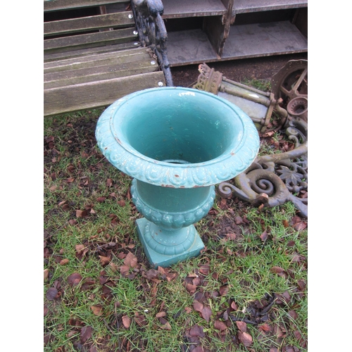 7037 - A pair of green painted cast urns, 39cm tall