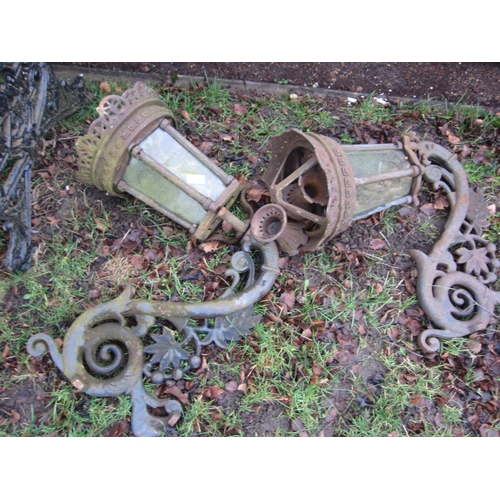 7038 - A pair of decorative cast iron lanterns with brackets