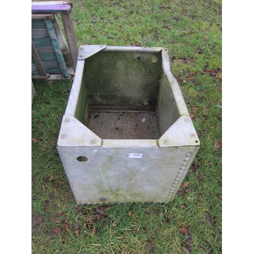 7085 - A riveted galvanised tank, 41cm x 59cm x 43cm, dented and one corner missing brace