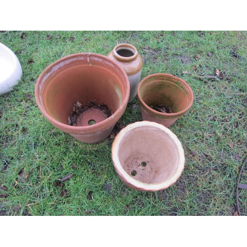 7112 - A large terracotta pot, small pot, glazed pot and a glazed storage jar (4)