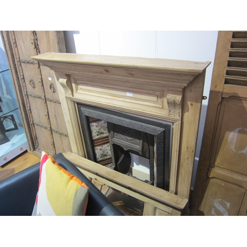 7452 - A Victorian pine mirror backed fire surround with tiled cast iron fire insert