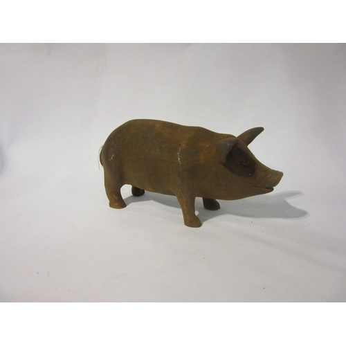 4169 - A rusty cast metal pig figure, 16cm long