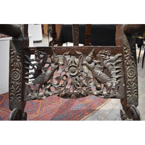 8616 - A highly ornate Thai carved wood easel decorated with flowers, figures and dragons.   77cm x 62cm