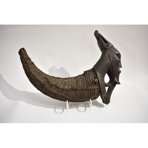 8619 - A Batak medicine horn Sumatra, Indonesia.  The horn body is rope bound with a carved wood Batak sing... 