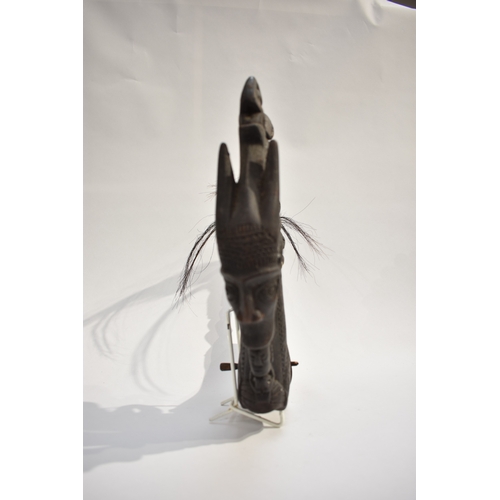 8620 - A Batak medicine horn Sumatra Indonesia.  The black horn body with incised pattern the apex carved w... 