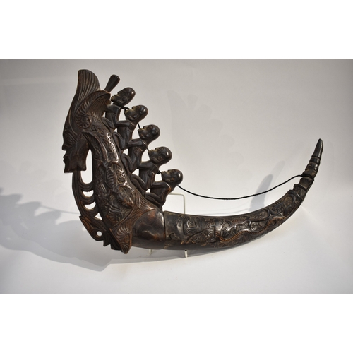 8623 - A Batak medicine horn Sumatra Indonesia.  The polished carved black horn carved with a dragon, lizar... 