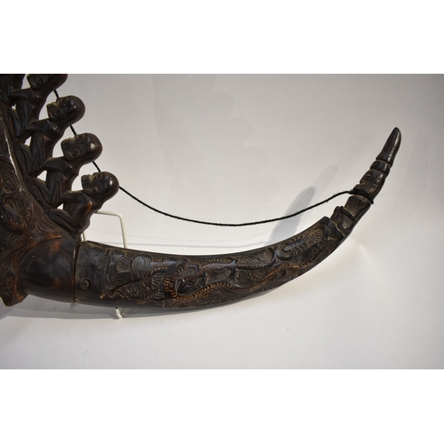 8623 - A Batak medicine horn Sumatra Indonesia.  The polished carved black horn carved with a dragon, lizar... 