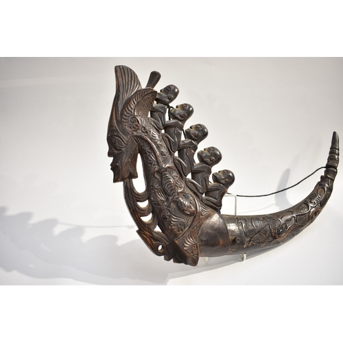 8623 - A Batak medicine horn Sumatra Indonesia.  The polished carved black horn carved with a dragon, lizar... 