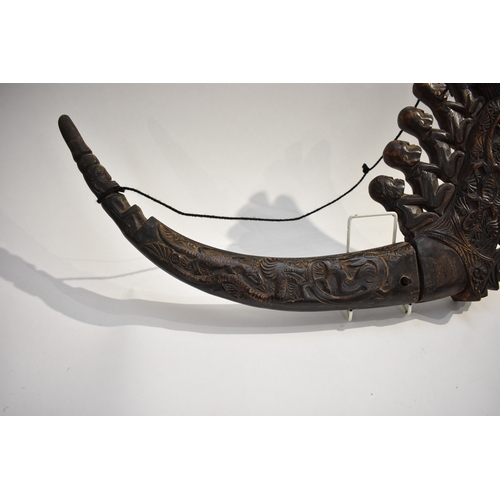 8623 - A Batak medicine horn Sumatra Indonesia.  The polished carved black horn carved with a dragon, lizar... 