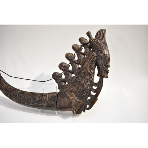 8623 - A Batak medicine horn Sumatra Indonesia.  The polished carved black horn carved with a dragon, lizar... 