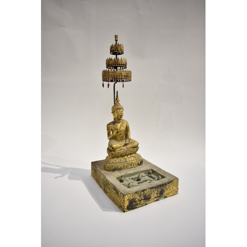 8630 - A gilded metal figure of a Shakyamuni Buddha sat underneath three canopies with pond to front. Hands... 