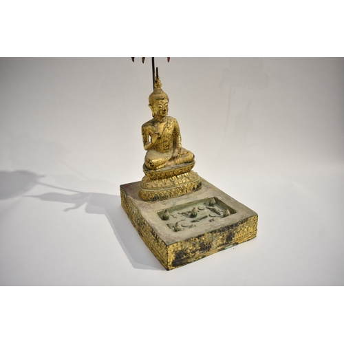 8630 - A gilded metal figure of a Shakyamuni Buddha sat underneath three canopies with pond to front. Hands... 