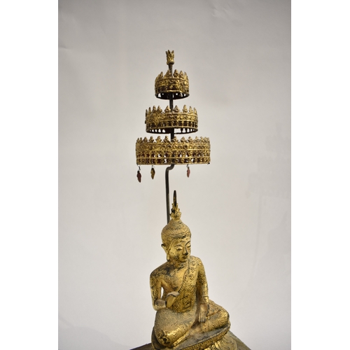 8630 - A gilded metal figure of a Shakyamuni Buddha sat underneath three canopies with pond to front. Hands... 