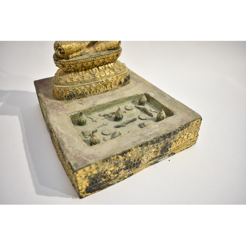 8630 - A gilded metal figure of a Shakyamuni Buddha sat underneath three canopies with pond to front. Hands... 