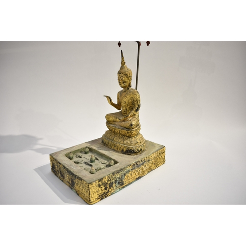 8630 - A gilded metal figure of a Shakyamuni Buddha sat underneath three canopies with pond to front. Hands... 