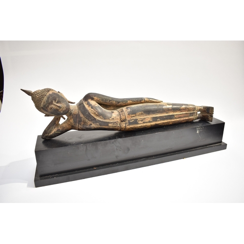 8631 - A Thai (Siam) gilded bronze reclining Buddha on associated plinth.  The gilding is extensively  worn... 