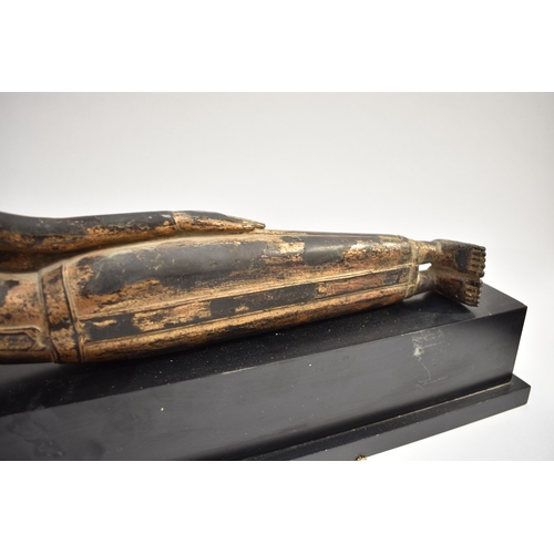 8631 - A Thai (Siam) gilded bronze reclining Buddha on associated plinth.  The gilding is extensively  worn... 