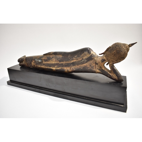 8631 - A Thai (Siam) gilded bronze reclining Buddha on associated plinth.  The gilding is extensively  worn... 