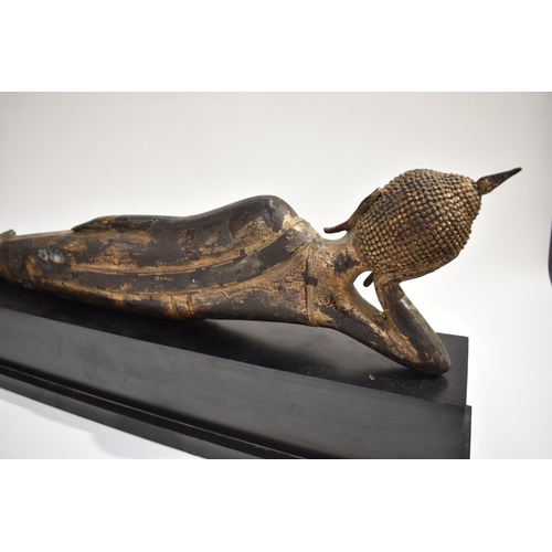 8631 - A Thai (Siam) gilded bronze reclining Buddha on associated plinth.  The gilding is extensively  worn... 