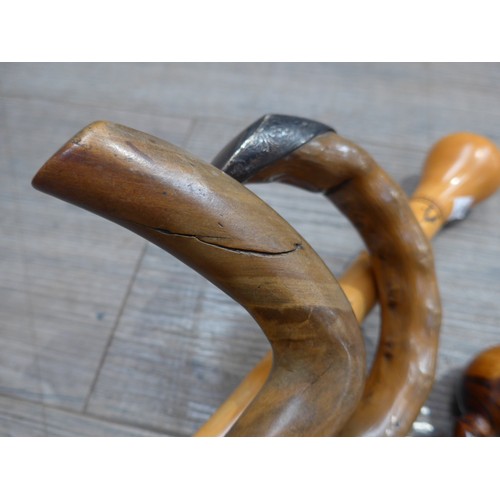 8612 - Four walking sticks/canes including walnut twist handle example