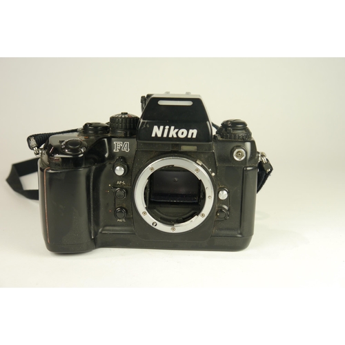 6029 - A Nikon F4 SLR 35mm film camera w/A Nikon AF Nikkor 28-80mm f/3.5-5.6 D zoom lens & Instructions