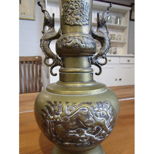 1002 - An Oriental twin handled brass vase. 35.5cm height