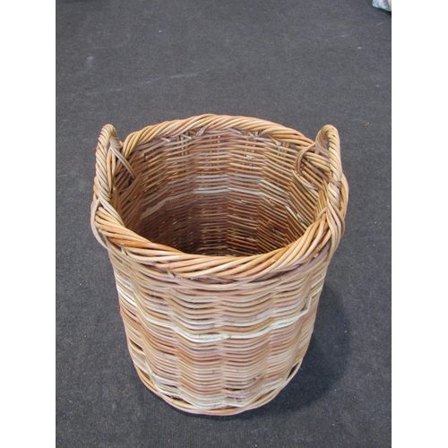 1021 - A cylindrical twin handled wicker log basket, 51cm tall x 40cm diameter