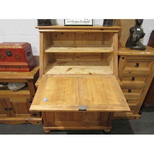 1037 - A pine writing bureau, drop-flap and cupboard door with shelved interior, 128cm tall x 86cm wide x 6... 