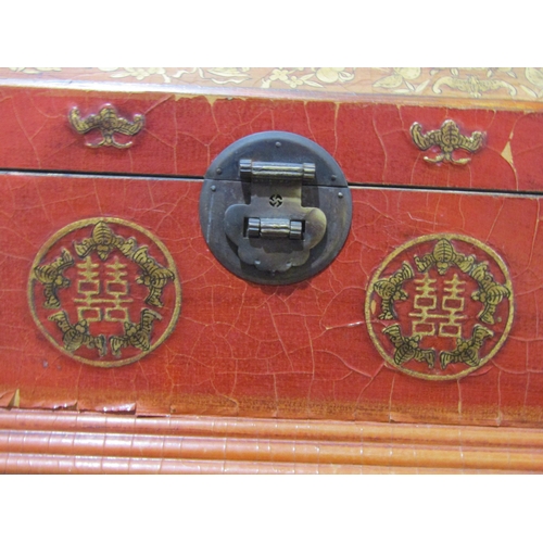 1038 - A Chinese influence red and gilt lacquered wooden jewellery box with mirrored interior and two drawe... 