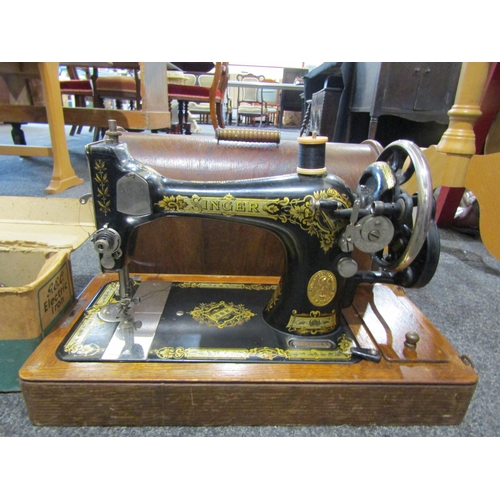 1064 - A Singer sewing machine, together with a G.E.C. electric iron