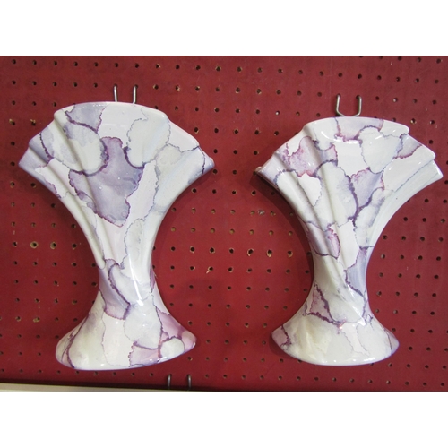 1066 - A pair of wall pockets in mottled purple and white glaze, 22cm tall