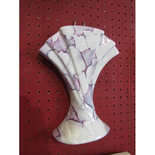 1066 - A pair of wall pockets in mottled purple and white glaze, 22cm tall