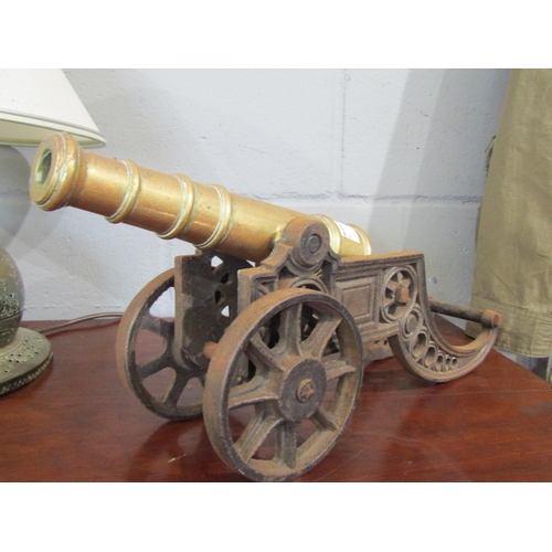 1091 - A pair of 19th Century miniature brass cannons on iron bases, 21cm tall x 45cm long