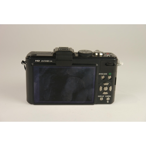 6099 - A cased Panasonic Lumix DMC-LX5 10MP Compact Digital Camera w/ Panasonic DE-A82 battery charger
**Un... 