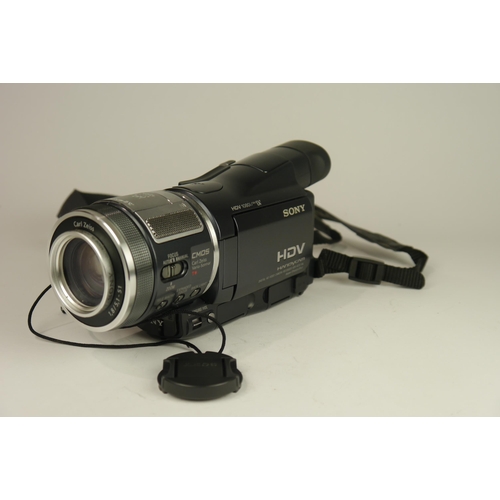 6065 - A Cased Sony HDR-HC1E Mini DV 1080i video camcorder w/ Two Sony conversions lens, Three battery's an... 