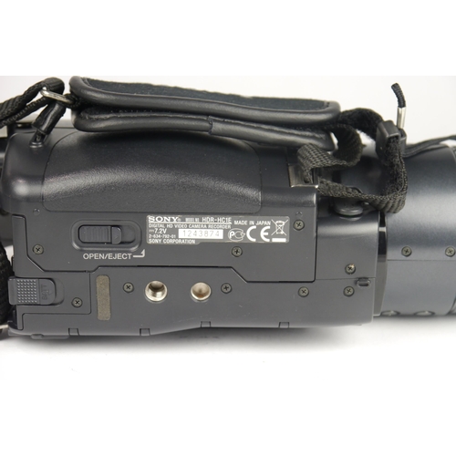 6065 - A Cased Sony HDR-HC1E Mini DV 1080i video camcorder w/ Two Sony conversions lens, Three battery's an... 