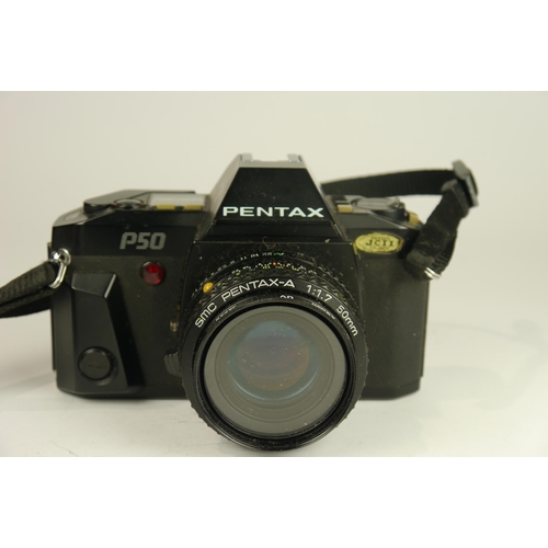 6088 - A Pentax ist D L2 DSLR camera w/ SMC Pentax DA 18-55mm f3.5-5.6 AL lens and manual. A Pentax P50 SLR... 