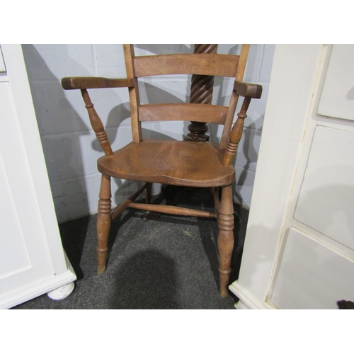 1015 - An elm seated Windsor chair, ladder back and turned supports on 'H' stretcher base