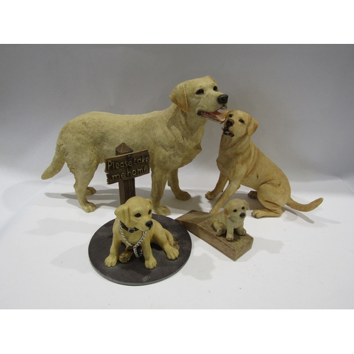 1423 - Two resin Golden Labradors, a small Labrador door wedge and another (4)