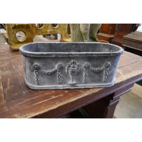 2007 - A pair of Regency style lead finish metal planters with swag and urn relief, 35cm long