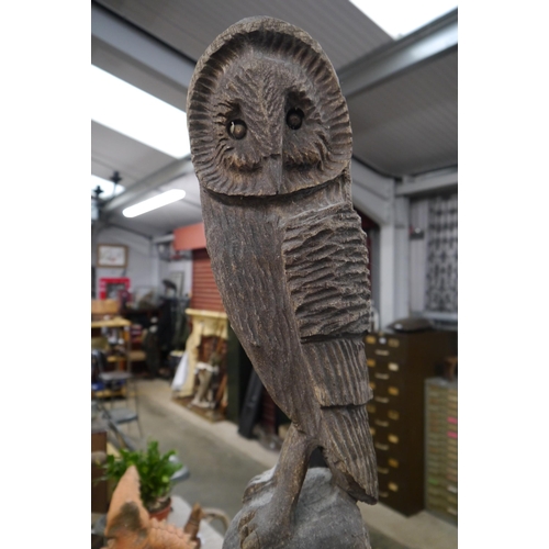 2020 - A weathered timber carving of an owl on mushrooms