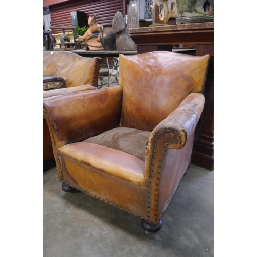 2027 - An Art Deco worn brown leather sofa and two arm chairs