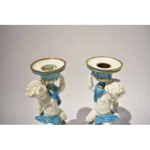 4078 - A pair of 19th Century Minton candlesticks, boys wrapped in cloth turquoise and gilt some rubbing pr... 