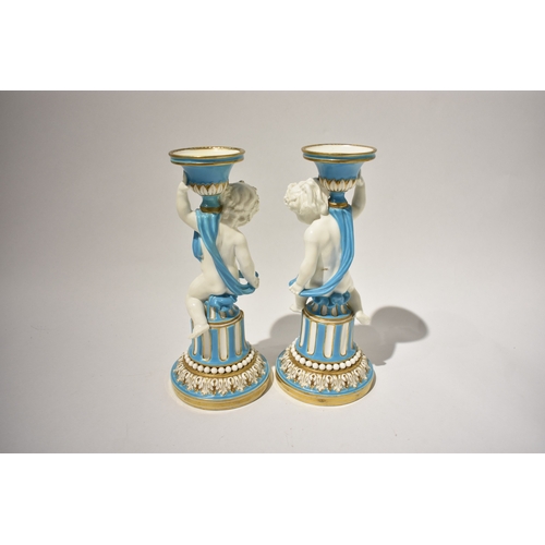 4078 - A pair of 19th Century Minton candlesticks, boys wrapped in cloth turquoise and gilt some rubbing pr... 