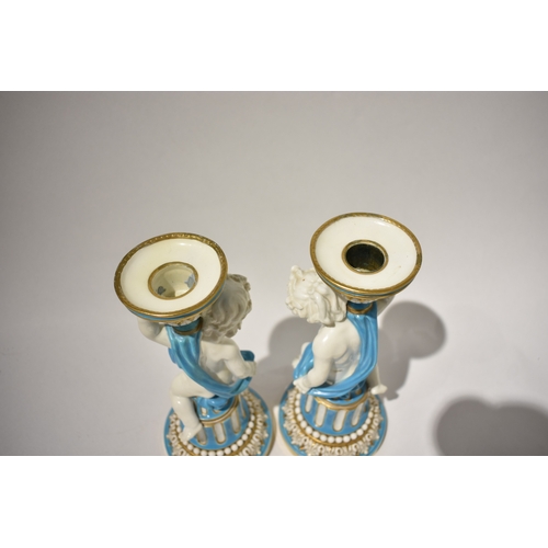 4078 - A pair of 19th Century Minton candlesticks, boys wrapped in cloth turquoise and gilt some rubbing pr... 